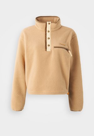 Beige fleece pullover with a high collar, half-button placket, and a left chest zip pocket. Textured fabric with brown accents.