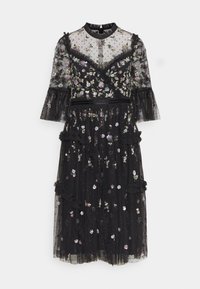 Robe noire à motif floral en tissu transparent, manches à volants et broderies détaillées. Présente un col montant et un design à étages.