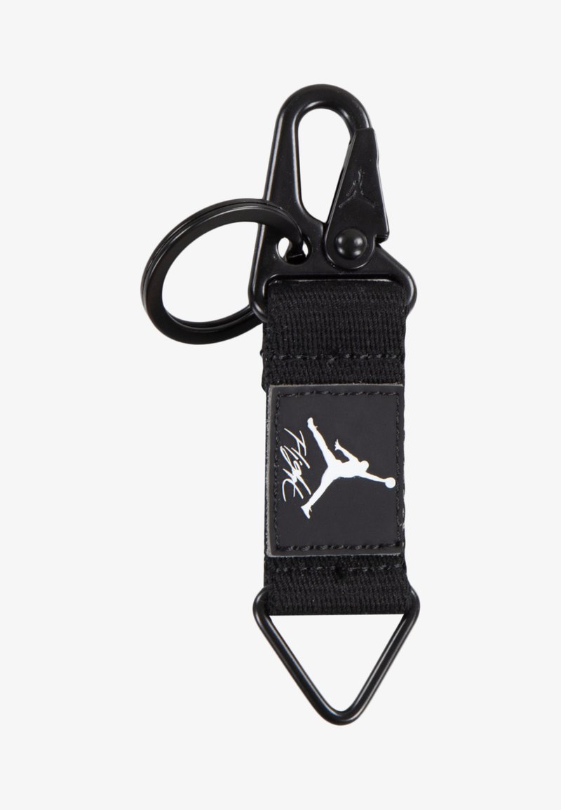 Svart nylon nøkkelring med metallklips og ring, med en rektangulær lapp som har en hvit Jumpman-logo og teksten "Flight".