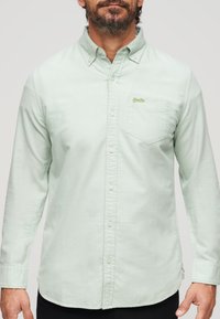 Mintgroene button-up shirt gemaakt van katoen, met een borstzak en een klein logo patch. Het shirt heeft een klassieke kraag en lange mouwen.