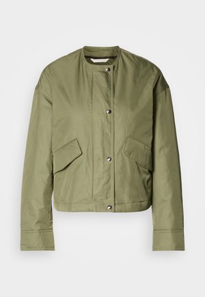 Veste cropped vert olive en tissu léger avec un col rond, des boutons-pression et deux poches latérales à ouvertures diagonales.