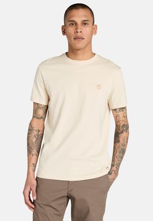 T-shirt in cotone beige con collo rotondo e maniche corte; presenta un piccolo logo tono su tono sul petto. Tessuto morbido e design aderente.