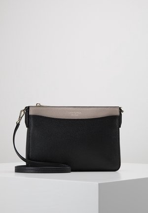 Sort og grå læder crossbody-taske med aftagelig rem, rektangulær form og glat tekstureret finish på en hvid piedestal.