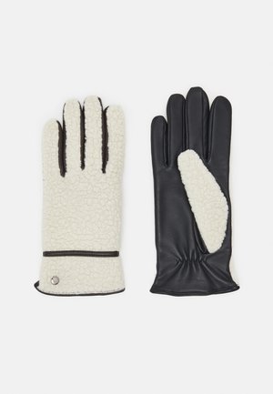 Fleece-lined gloves: cream-colored with black leather accents, featuring a textured surface, elastic wrist, and contrasting thumb panel.