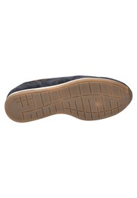 Semelle de chaussure en suède noir avec une semelle extérieure en caoutchouc tan. Présente un motif hexagonal texturé et des rainures pour une meilleure adhérence.
