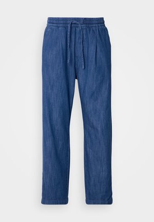 Sinine teksapüks, millel on paelaga elastne vöökoht. Sirge lõikega, ilma nähtavate taskute või kaunistusteta. Pehme tekstuur.