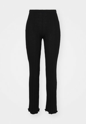 Black ribbed pants with a flared bottom, featuring a textured design and an elastic waistband. Smooth, lightweight fabric with a fitted silhouette.