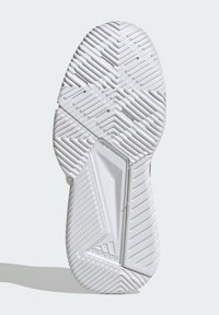 Hvid gummisål til sko med tekstureret mønster, der indeholder zigzag- og sildebenmønstre. Indeholder et ventileret afsnit og logodetalje.