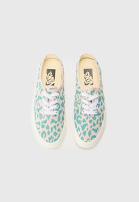 Light blue sneakers with a pink leopard print pattern. White laces, rounded toe, and a beige rubber sole. Branding on the insoles.