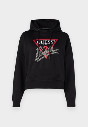 Black cropped hoodie with a drawstring hood, featuring a red triangular logo and silver embellishments on the front. Smooth texture.