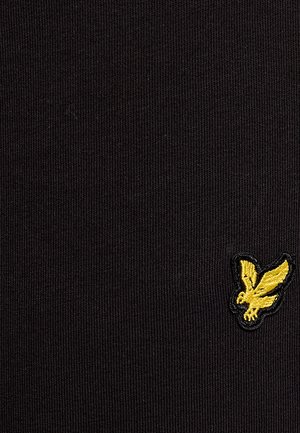 Tissu noir texturé présentant un petit logo brodé jaune représentant un oiseau. Le design est simple avec un motif côtelé.