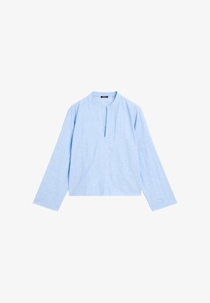 Light blue long-sleeve blouse with a round neckline and a front slit. Made of textured fabric, featuring a loose, cropped fit.