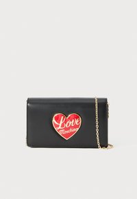 Black leather crossbody bag with gold chain strap and red heart emblem reading "Love Moschino" on front flap.
