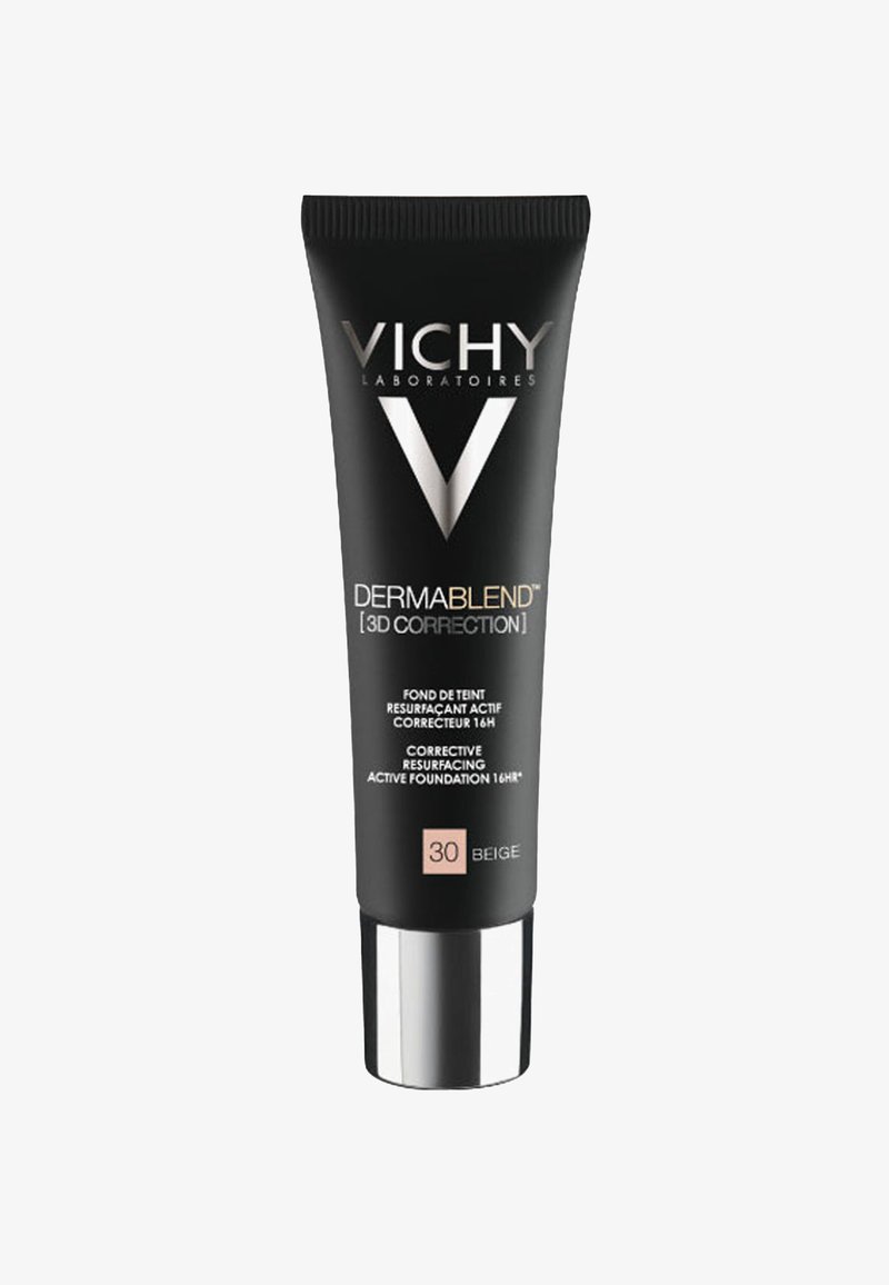 Black squeeze tube of Vichy Dermablend foundation, with silver cap, labeled “30 Beige.” Text highlights corrective and long-lasting features.