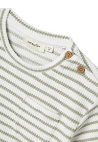 Striped cotton t-shirt in white and sage green, featuring ribbed texture, a small pocket, and two textured wooden buttons on the shoulder.