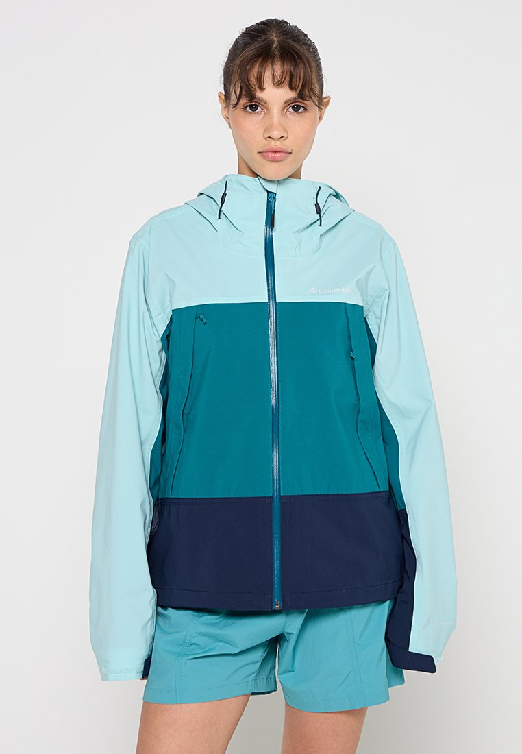 Columbia jacket featuring a hood, color-blocked design in light blue, teal, and navy, with a zipper front and adjustable toggles.