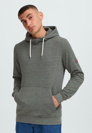 Gray hoodie made of soft material with a drawstring hood, front pocket, and ribbed cuffs. Features a small logo patch on the sleeve.