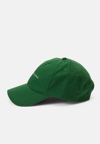 Boné de algodão verde com a aba curva, apresentando texto bordado na frente e ilhós para ventilação. Design simples e sem adornos.