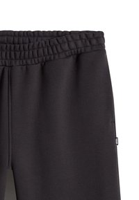 Schwarze Jogginghose mit elastischem Bund, glatter Textur und Seitentaschen; mit kleinem Logotag an der Seite.