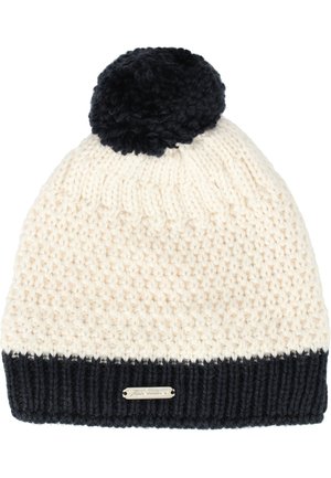 Strikket hue i creme og marineblå, med en tekstureret krop, ribbet marineblå manchet og en fluffy marineblå pom-pom på toppen. Metalllogo detaljer inkluderet.