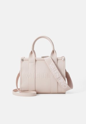Pale pink leather handbag with dual top handles, detachable strap, embossed logo, structured design, and smooth texture.