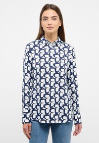 Button-up shirt in navy and white with a geometric pattern. Made of smooth fabric, features a collar and long sleeves, with a straight hem.