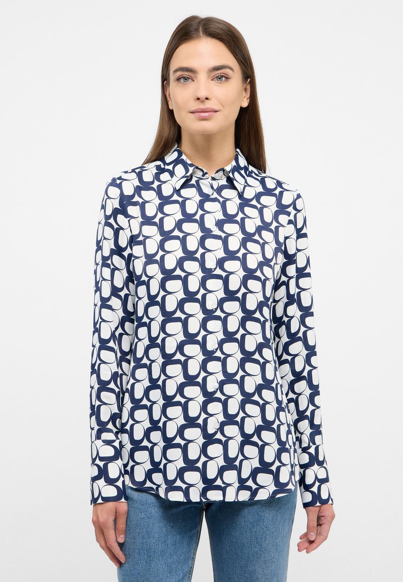 Button-up shirt in navy and white with a geometric pattern. Made of smooth fabric, features a collar and long sleeves, with a straight hem.