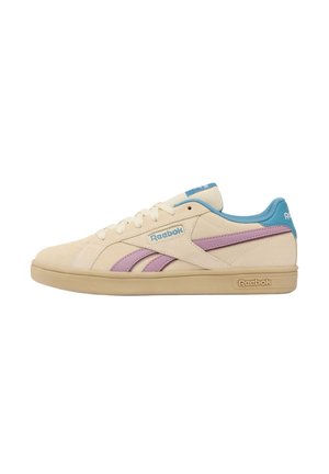 Beige Reebok sneaker with purple side stripes, blue padded collar, blue logo on tongue, and beige sole with Reebok branding.
