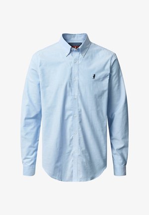 Chemise bleu clair à manches longues, avec col pointu et un petit logo brodé sur la poitrine. Fabriquée en tissu lisse.