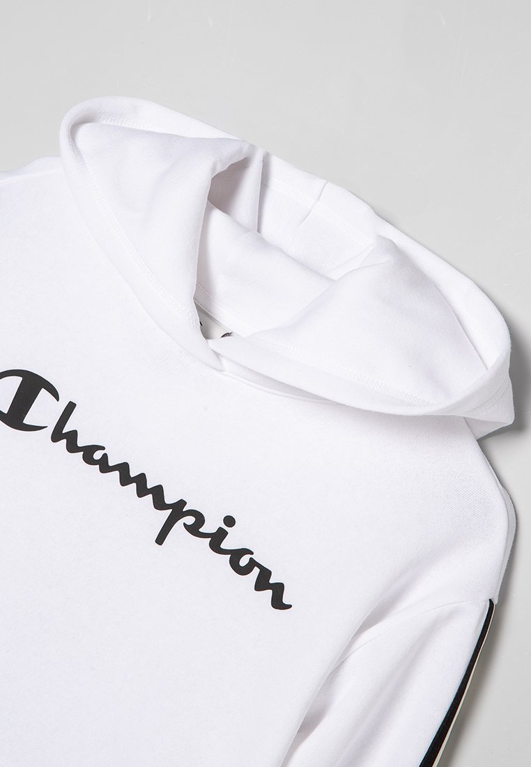 Felpa bianca in cotone con il logo nero "Champion", cappuccio e strisce nere a contrasto lungo le maniche. Texture liscia, design casual.