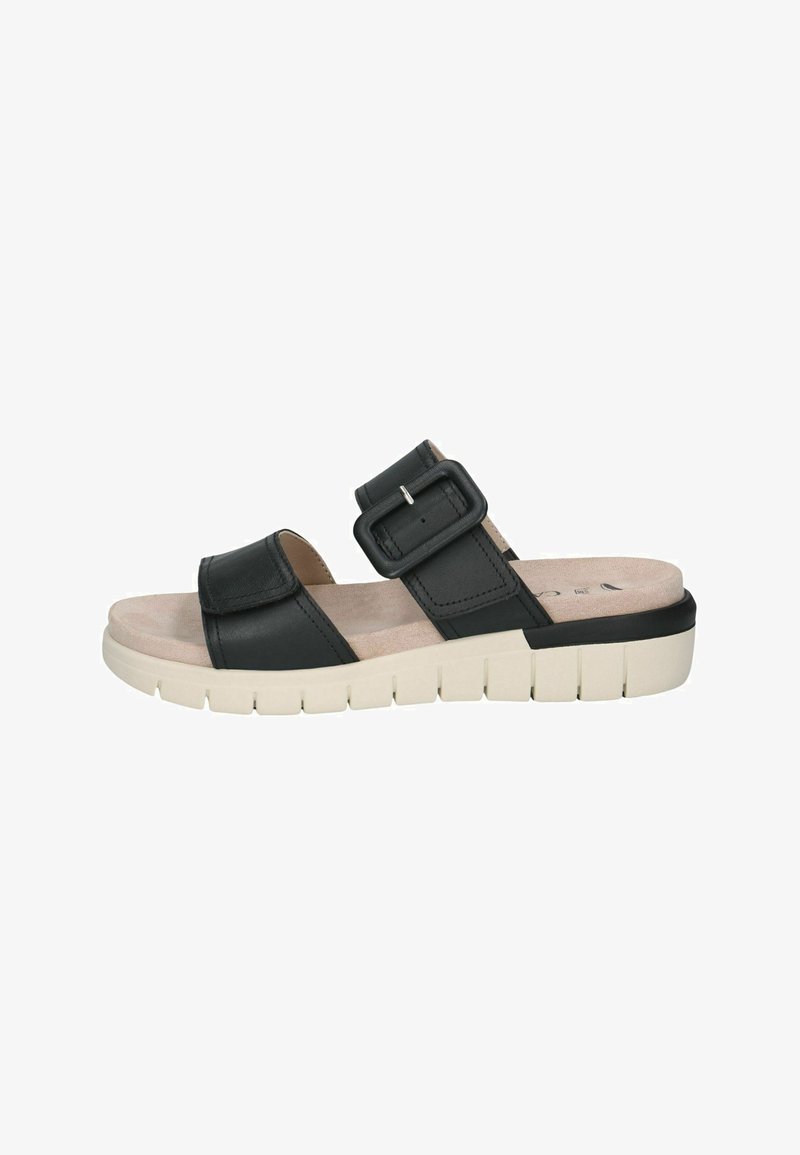 Sandales mules en cuir noir avec une large bride et une boucle ajustable, semelle intérieure beige rembourrée et semelle extérieure blanche rainurée pour une meilleure adhérence.