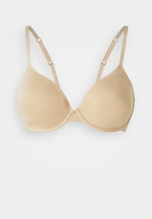 Nude gevoerde bh van soepel, zacht materiaal, met driehoekige cups, verstelbare smalle bandjes en een haak-en-oogsluiting op de rug.