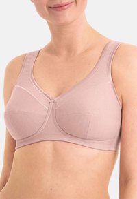 Soutien-gorge sans fil rose clair avec larges bretelles, tissu texturé et un délicat bouton au centre. Conçu pour le confort et le soutien.