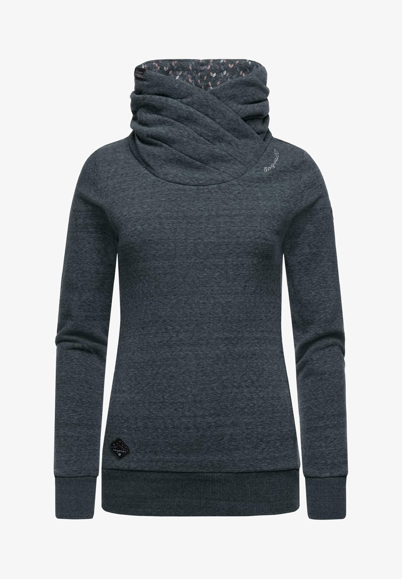 Tumši pelēks sporta krekls ar cowl apkakli, garām piedurknēm un elastīgiem aproces galiem. Iezīmēts ar rakstainu iekšējo oderi un mazu logotipu apakšmalā.