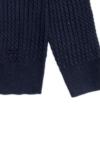 Maglione in blu navy lavorato a maglia con un design testurizzato a coste, dotato di un'etichetta logo a contrasto e di polsini elasticizzati. Realizzato in un tessuto morbido.