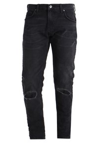 Černé úzké dž�ínové kalhoty s roztrženými koleny, vybavené klasickým designem s pěti kapsami, kovovým knoflíkem a zapínáním na zip.