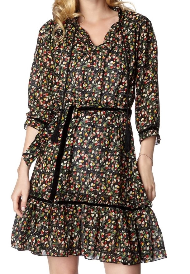 Svart blommig klänning med färgglad bladmönster, trekvart ärmar, volangkant och ett svart bälte som framhäver midjan.
