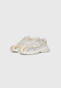 White and gold athletic shoes with a textured mesh upper, metallic accents, thick sole, and reinforced toe for durability.