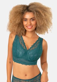 Türkise Spitzen-Bralette mit Wickeldesign, das komplizierte florale Muster, gewellte Kanten und verstellbare Träger aufweist. Weiches, strukturiertes Material.