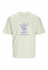 Cream cotton t-shirt with short sleeves featuring a purple cartoon graphic and text "I told you" below. Relaxed fit and crew neckline.