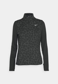 Svart långärmad tröja med kvartslång dragkedja som har ett mönster av små vita prickar och en reflekterande Nike-logotyp på vänster bröst.