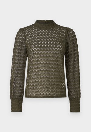 Olive green long-sleeve top featuring a textured honeycomb pattern, high neckline, and gathered shoulder details with fitted cuffs.
