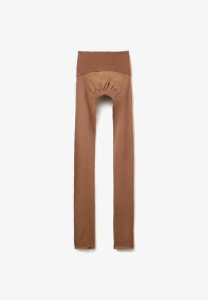Brown full-length leggings with a high waist and gathered, cutout detail. Made from smooth, stretchy fabric with a matte finish.