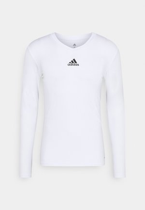 Langærmet hvid sports T-shirt lavet af glat materiale med et sort Adidas-logo på brystet; V-hals design og tætsiddende pasform.