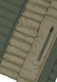 Padded jacket featuring a dark green exterior and a lighter olive interior, with vertical quilted sections and a zippered pocket detail.