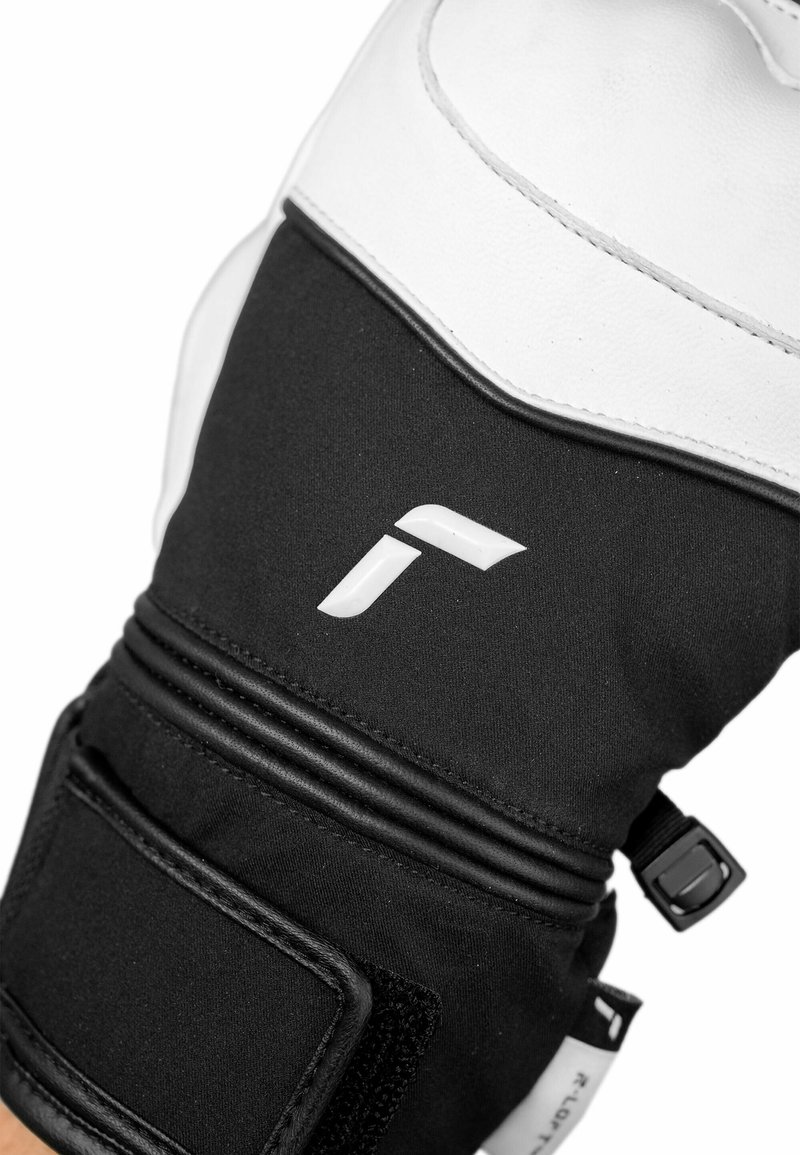 Black and white motorcycle glove featuring a soft leather palm, nylon fabric body, textured accents, and adjustable Velcro wrist closure.