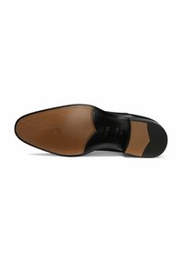 Black leather shoe sole with a tan section, featuring a smooth finish and decorative stitching along the edge. Rounded toe and slight heel.
