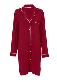Camicia da pigiama rossa con maniche lunghe, rifiniture bianche lungo il colletto e la tasca, chiusura con bottoncini, realizzata in materiale morbido. Tasca a sinistra.