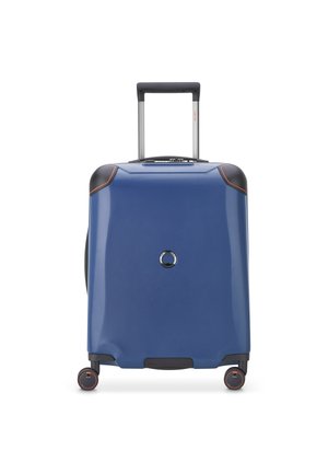 Hard-shell suitcase in blue with black accents, extendable handle, four wheels, textured surface, and a circular lock feature on the front.