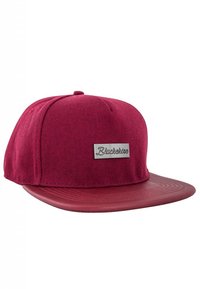 Maroon snapback cap with a textured fabric body and a smooth flat peak. Features a silver logo plate on the front.